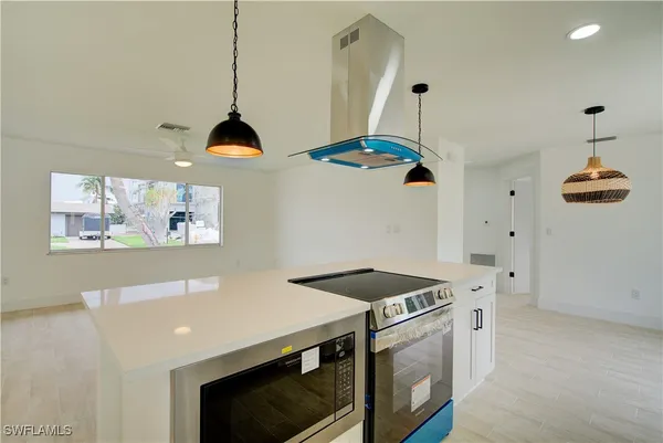 a kitchen with stainless steel appliances a stove a sink and a refrigerator
