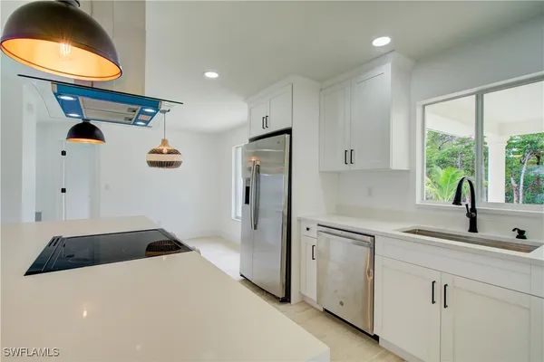 a kitchen with a sink and a refrigerator