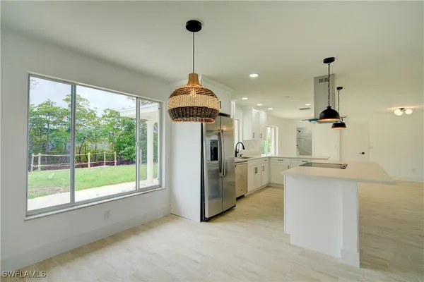 a open kitchen with stainless steel appliances granite countertop a stove and refrigerator