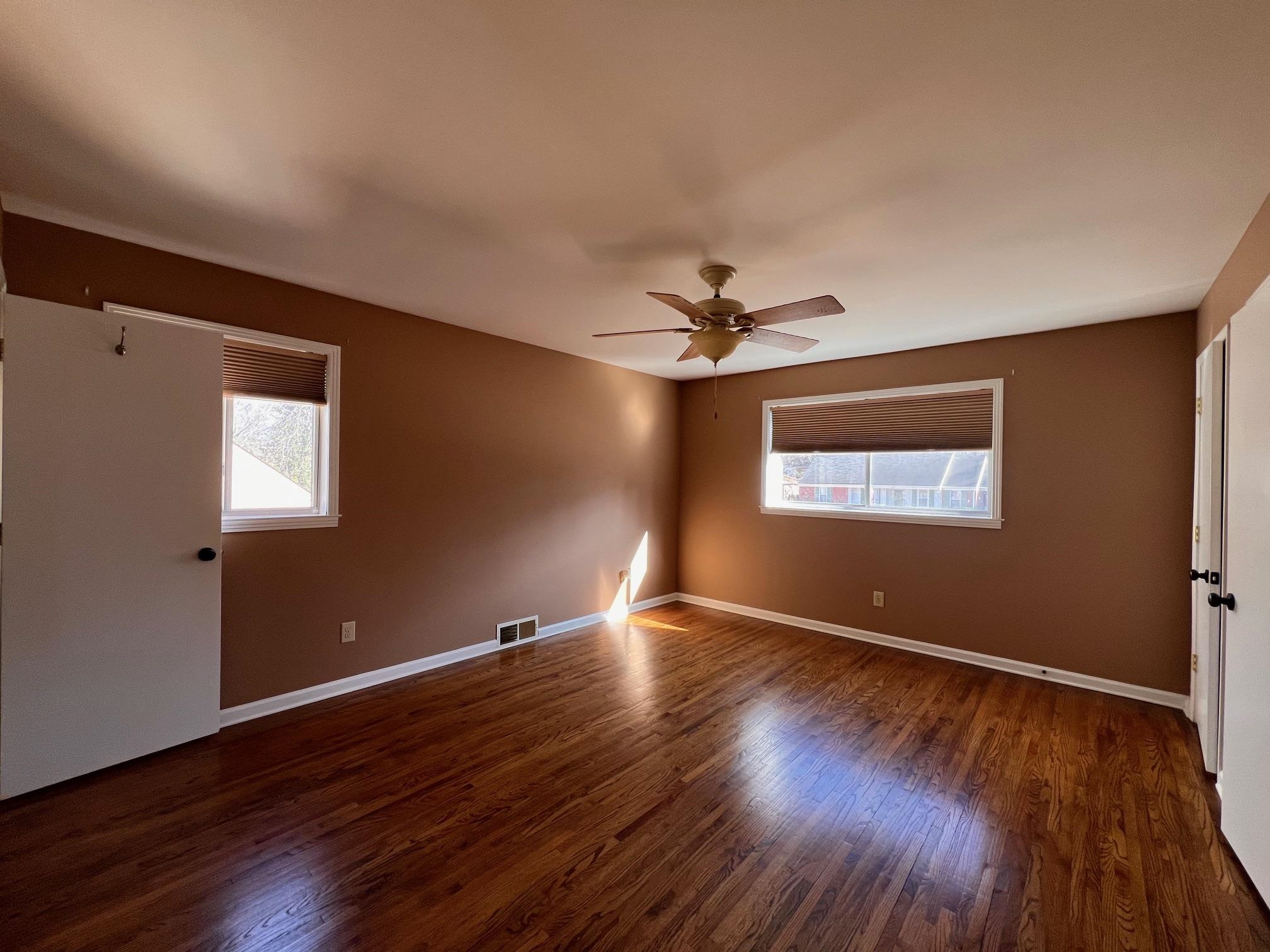 3034 Laurencekirk Road Memphis, TN 38128 - Photo 11 of 27 a view of an empty room with wooden floor and a window