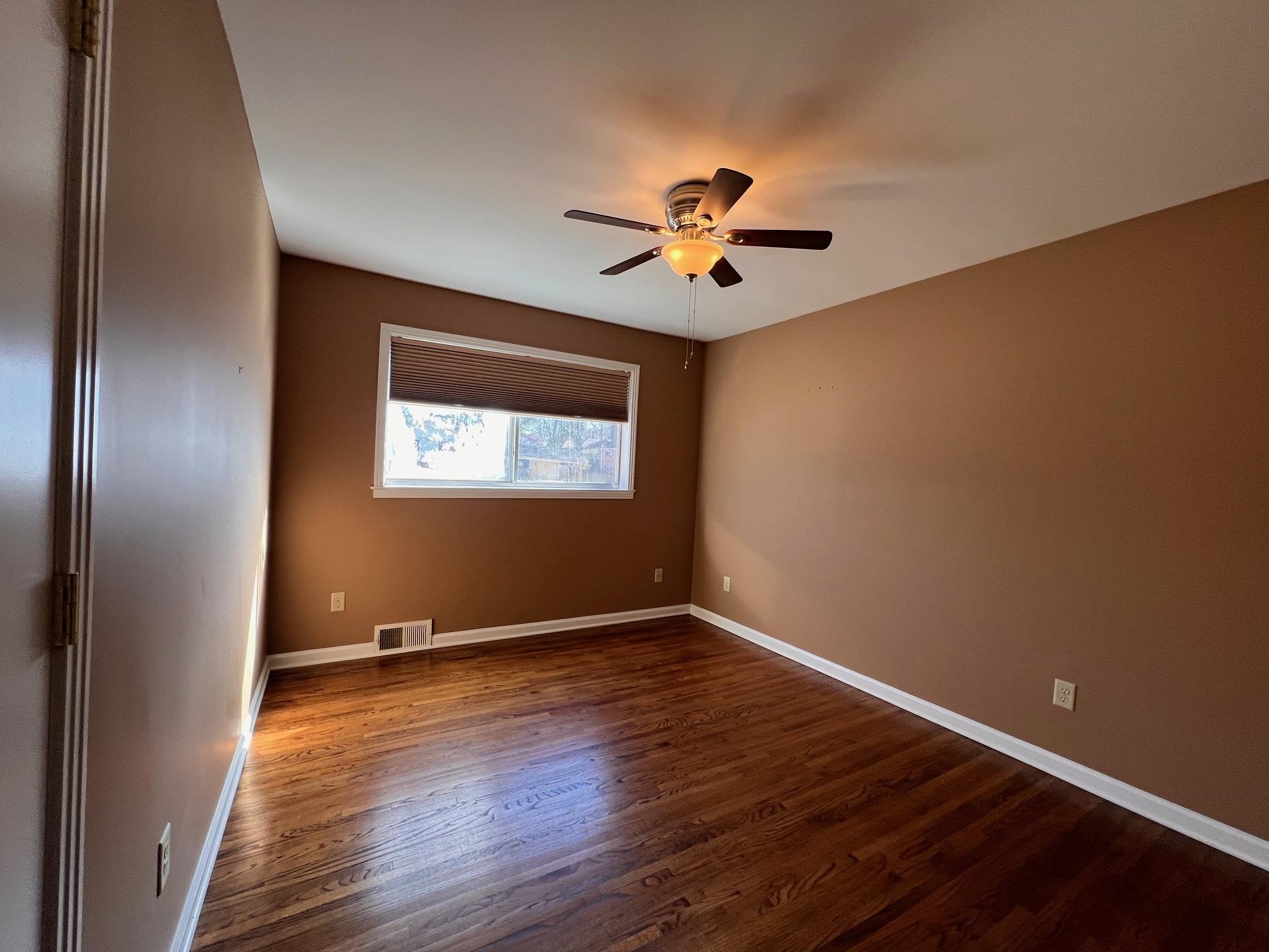 3034 Laurencekirk Road Memphis, TN 38128 - Photo 15 of 27 a view of room with wooden floor and ceiling fan