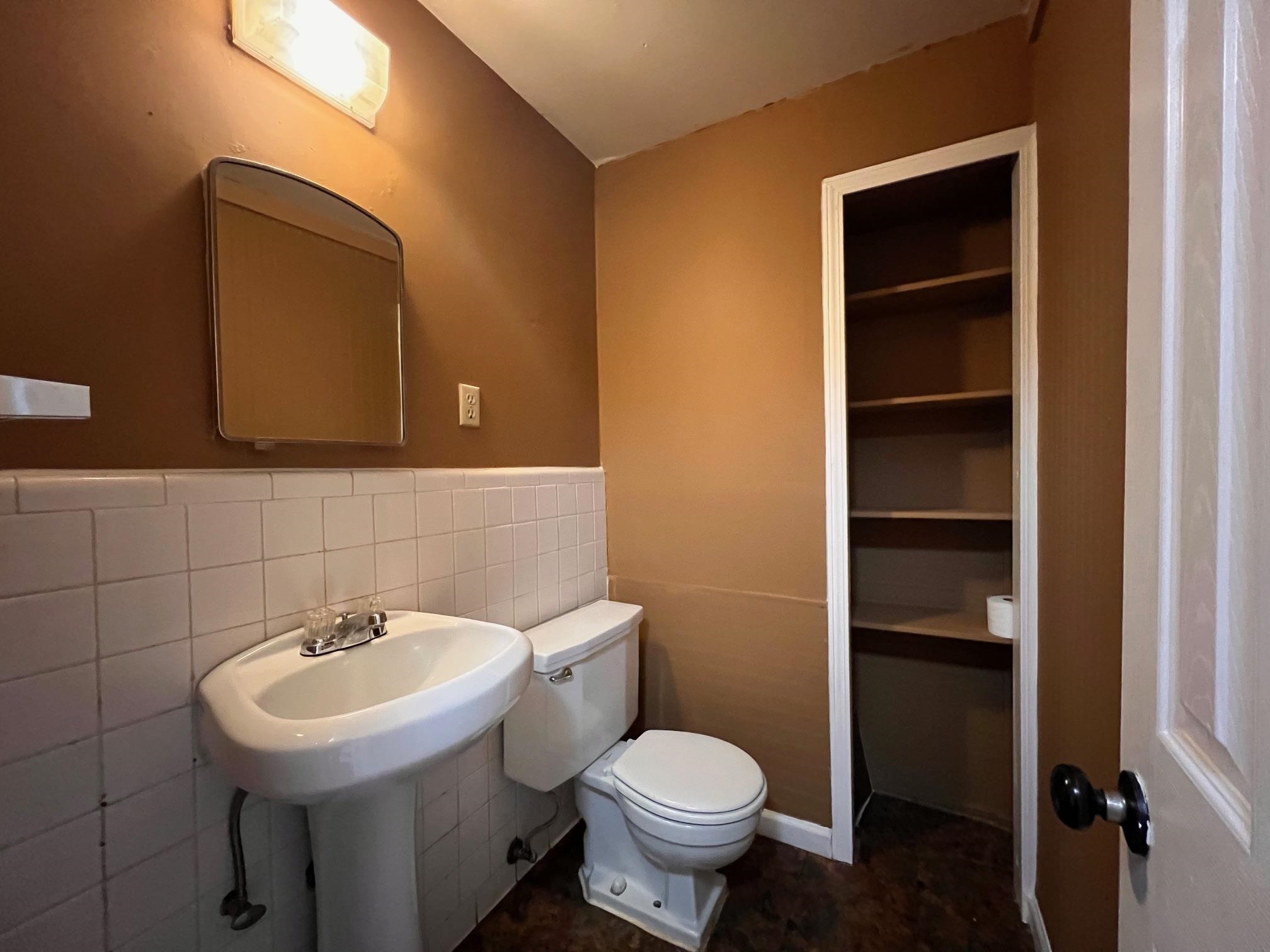 3034 Laurencekirk Road Memphis, TN 38128 - Photo 16 of 27 a bathroom with a sink toilet and mirror