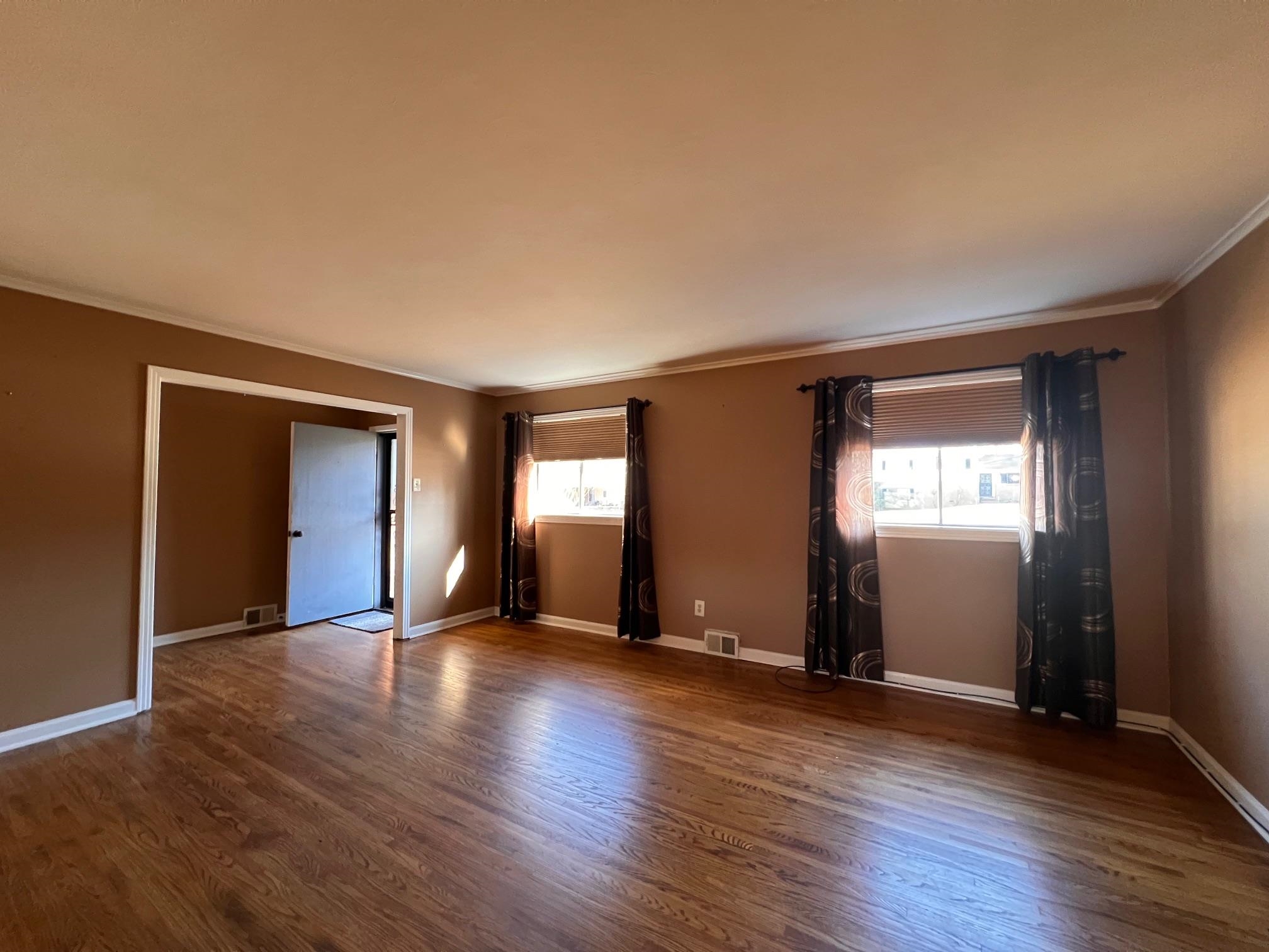 3034 Laurencekirk Road Memphis, TN 38128 - Photo 7 of 27 an empty room with wooden floor and windows