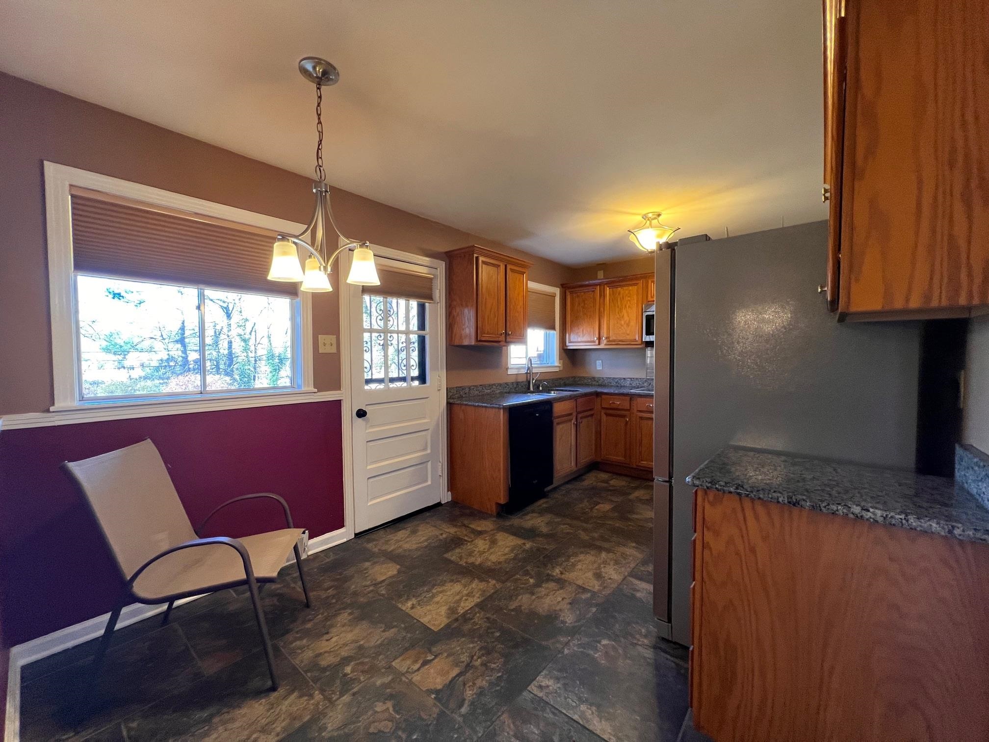 3034 Laurencekirk Road Memphis, TN 38128 - Photo 9 of 27 a kitchen with stainless steel appliances granite countertop a refrigerator a sink a stove and a wooden floors