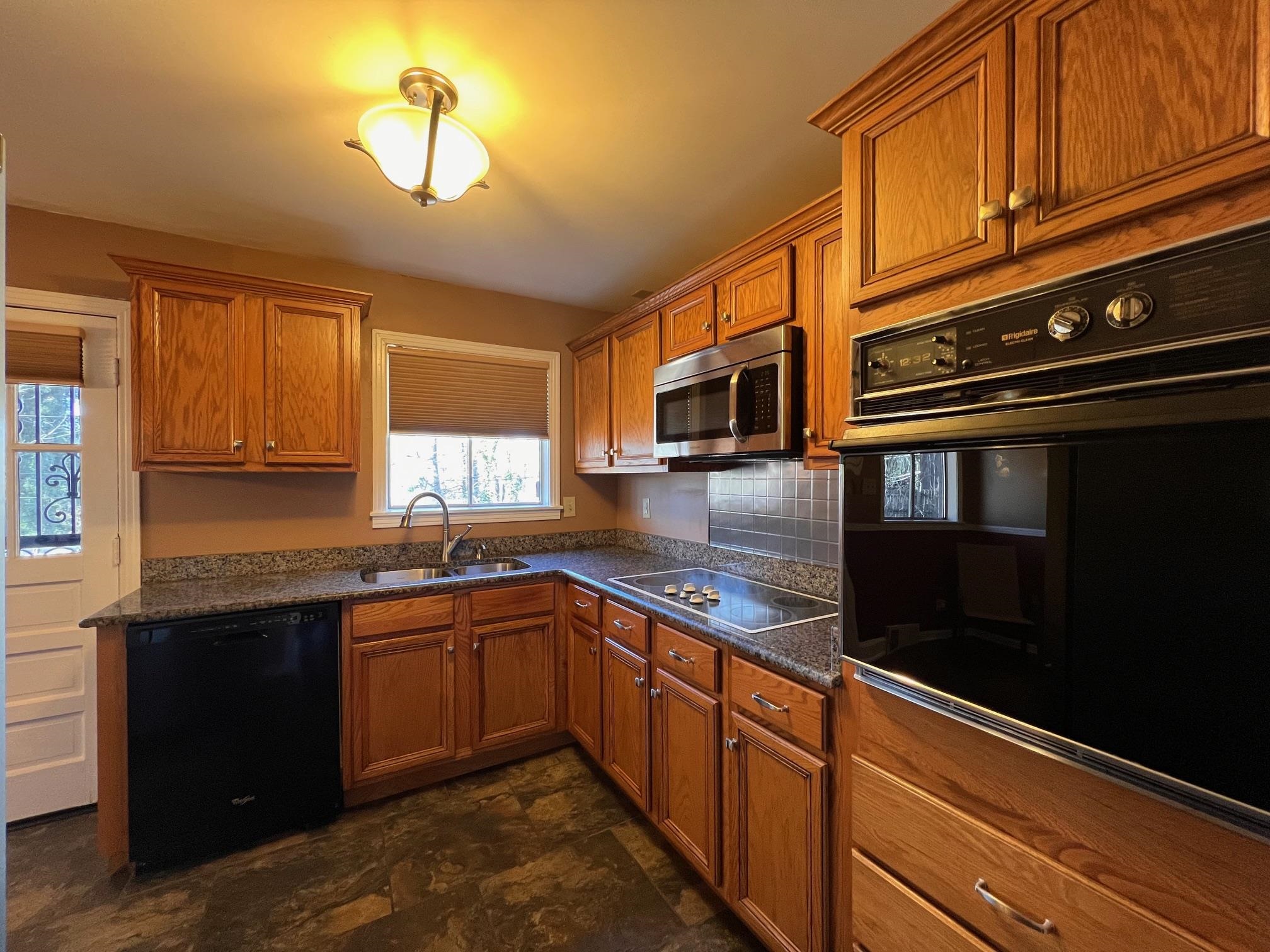 3034 Laurencekirk Road Memphis, TN 38128 - Photo 10 of 27 a kitchen with stainless steel appliances granite countertop a sink stove and microwave