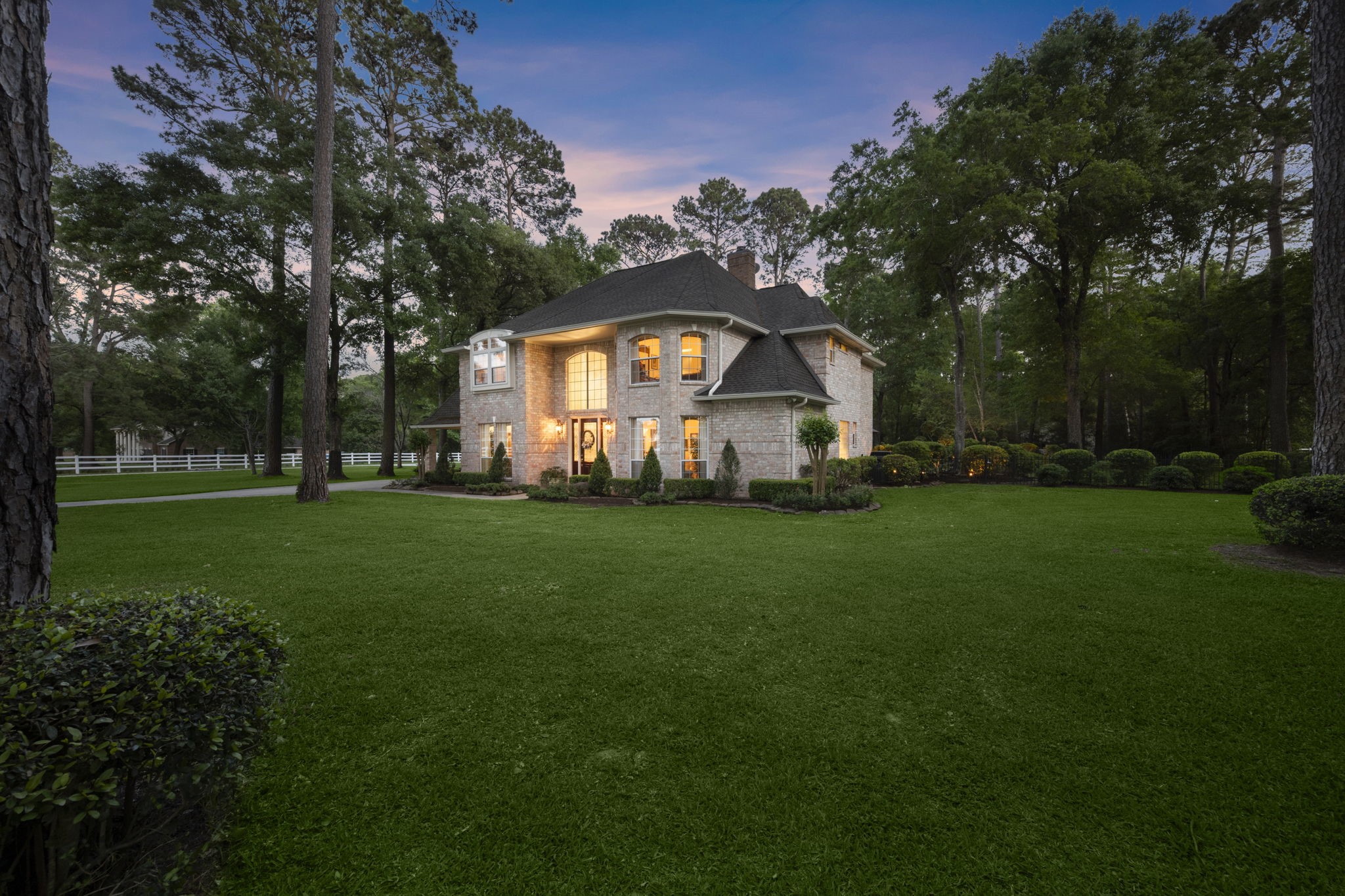 9913 Kleppel Road Tomball, TX 77375 - Photo 1 of 50 a view of a white house with a big yard and large trees