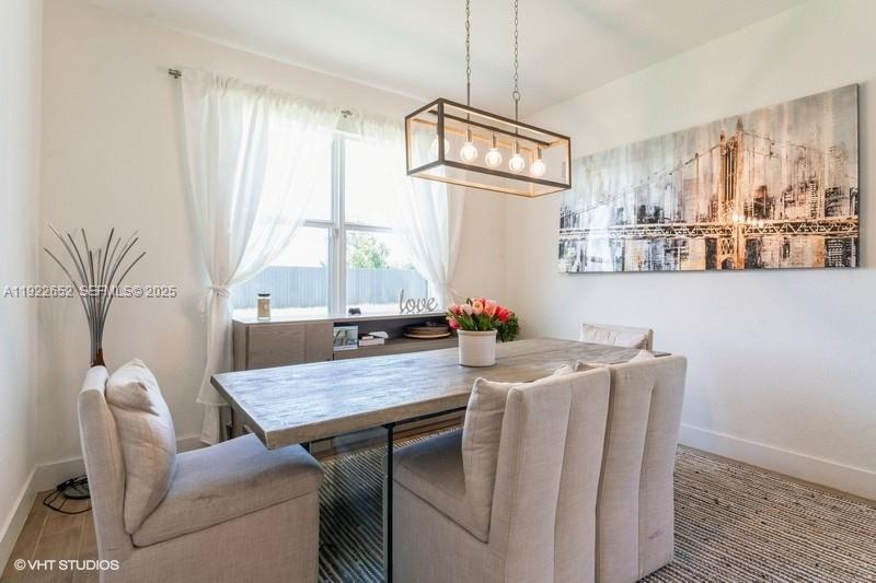 16033 Southwest 277th Street Homestead, FL 33031 - Photo 14 of 37 a view of a dining room with furniture window and outside view