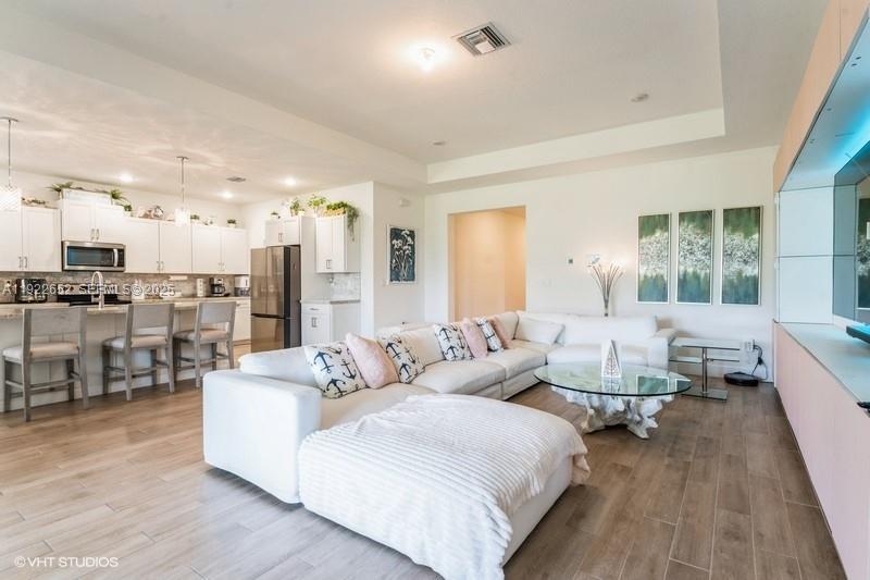 16033 Southwest 277th Street Homestead, FL 33031 - Photo 18 of 37 a living room with furniture and a large window