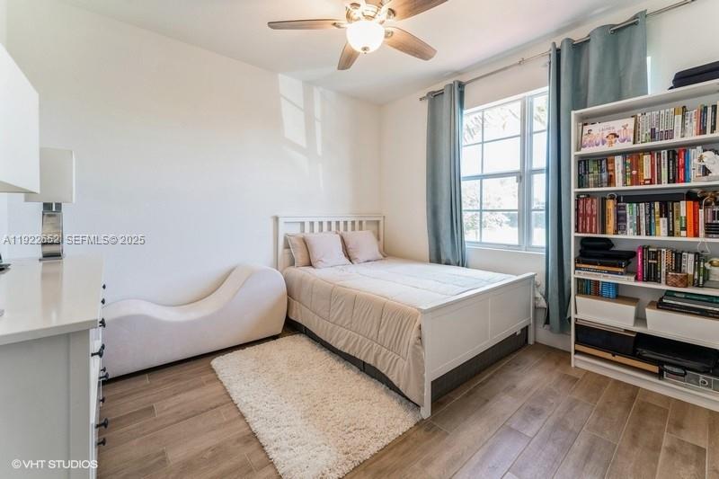16033 Southwest 277th Street Homestead, FL 33031 - Photo 20 of 37 a bedroom with a bed furniture and a book shelf