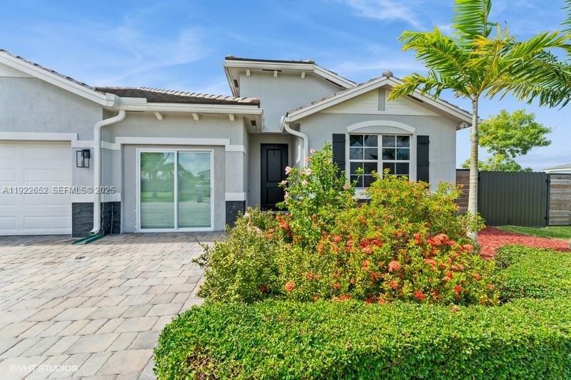 16033 Southwest 277th Street Homestead, FL 33031 - Photo 2 of 37 front view of a house with a yard
