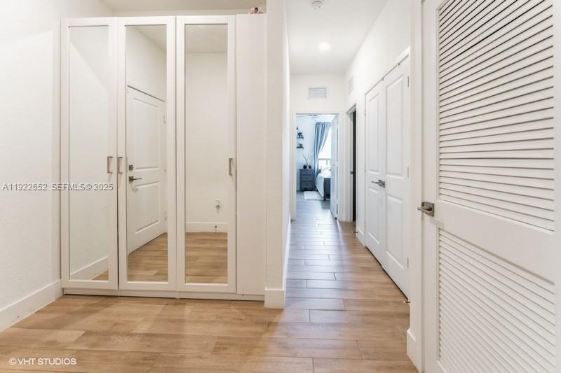 16033 Southwest 277th Street Homestead, FL 33031 - Photo 24 of 37 a view of a hallway with wooden floor and closet