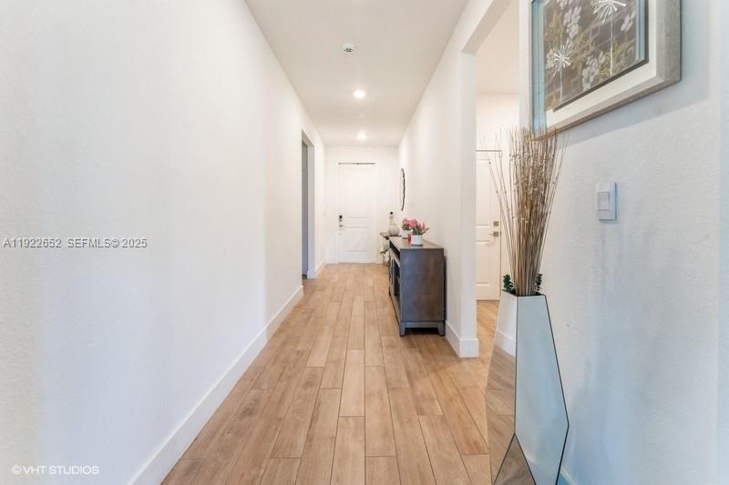 16033 Southwest 277th Street Homestead, FL 33031 - Photo 28 of 37 a view of a hallway with wooden floor and staircase