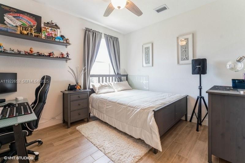 16033 Southwest 277th Street Homestead, FL 33031 - Photo 30 of 37 a bedroom with a bed and a desk