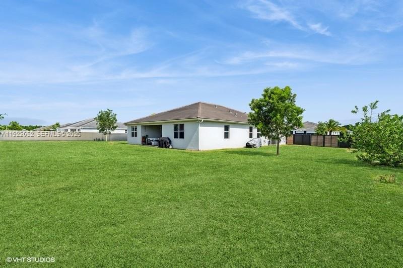 16033 Southwest 277th Street Homestead, FL 33031 - Photo 3 of 37 a front view of a house with a yard