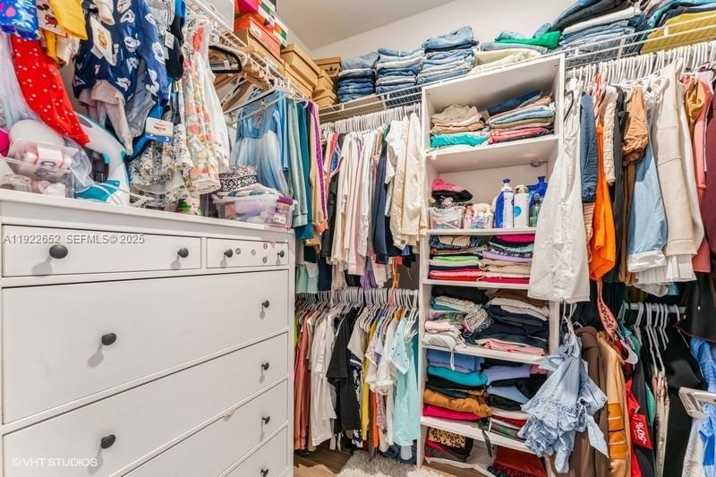 16033 Southwest 277th Street Homestead, FL 33031 - Photo 32 of 37 a view of walk in closet with clothes and shoes