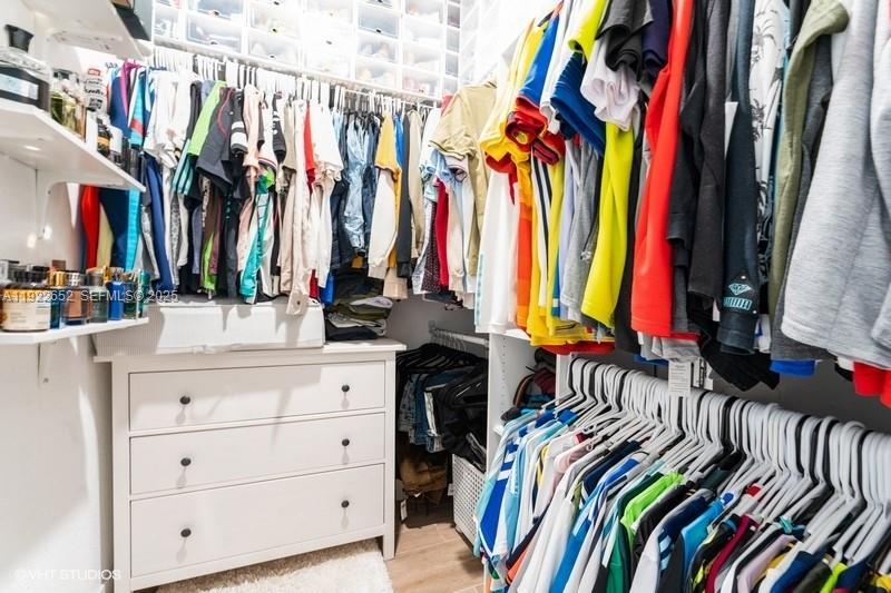 16033 Southwest 277th Street Homestead, FL 33031 - Photo 33 of 37 a view of walk in closet with clothes