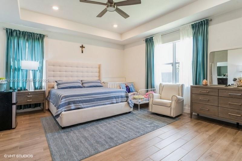 16033 Southwest 277th Street Homestead, FL 33031 - Photo 34 of 37 a bedroom with a bed and wooden floor