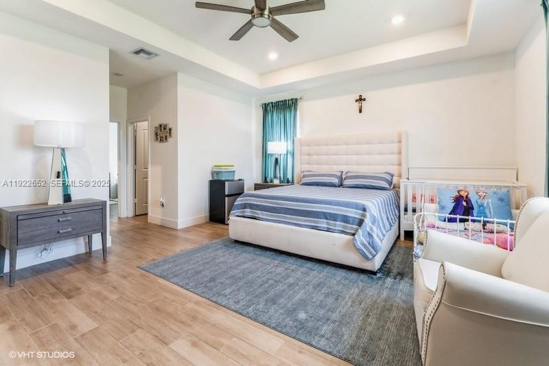 16033 Southwest 277th Street Homestead, FL 33031 - Photo 35 of 37 a bedroom with a bed and furniture