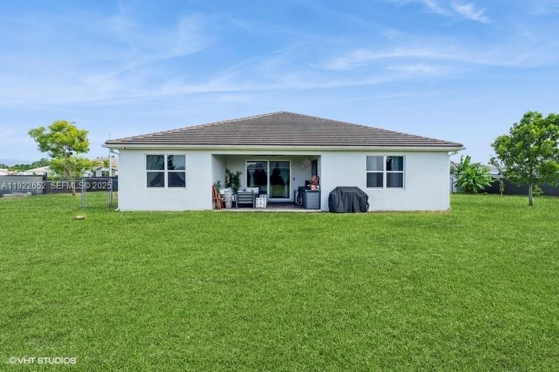 16033 Southwest 277th Street Homestead, FL 33031 - Photo 4 of 37 a view of a house with backyard and garden