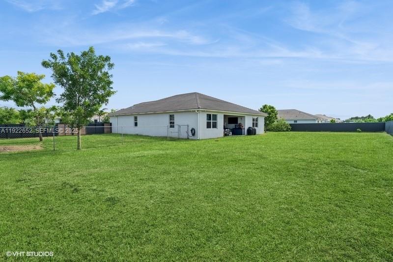 16033 Southwest 277th Street Homestead, FL 33031 - Photo 5 of 37 a large house with a big yard and large trees