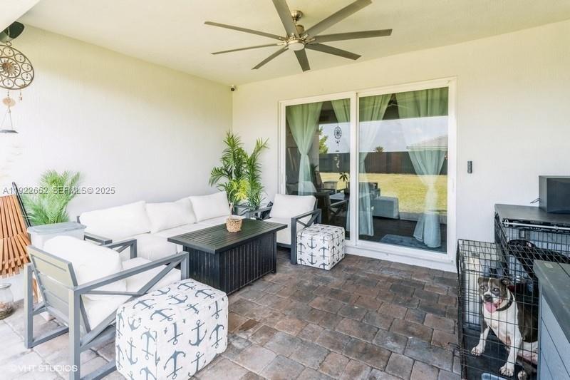 16033 Southwest 277th Street Homestead, FL 33031 - Photo 7 of 37 a living room with furniture a rug and a floor to ceiling window