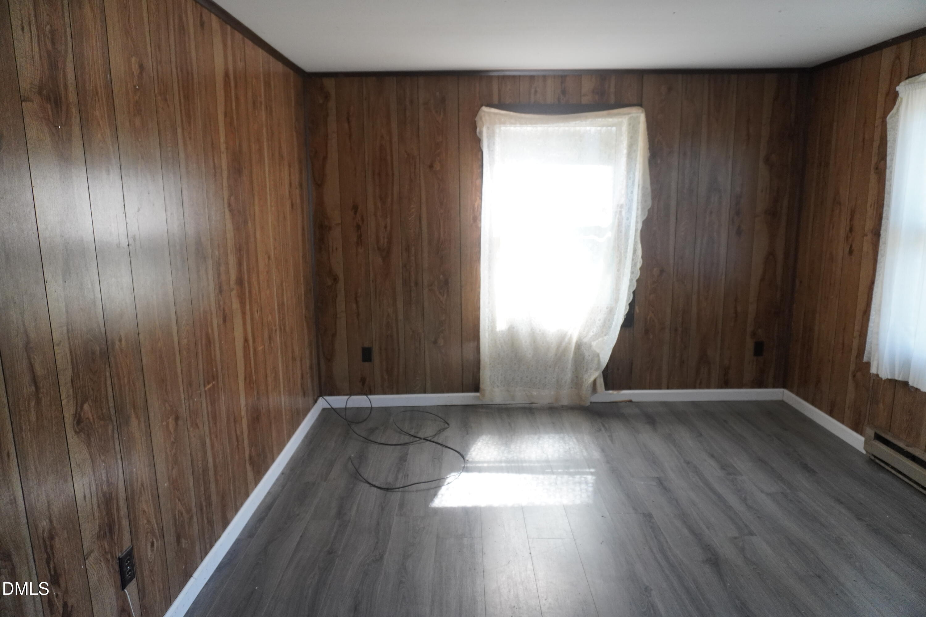 179 Lynnbank Estates Road Kittrell, NC 27544 - Photo 4 of 16 an empty room with wooden floor and windows