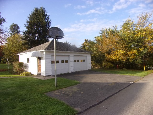 334 Madison Street Sligo, PA 16255 - Photo 6 of 24 a front view of a house with a yard and garage