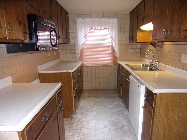 334 Madison Street Sligo, PA 16255 - Photo 9 of 24 a kitchen that has a sink a stove and a table in it