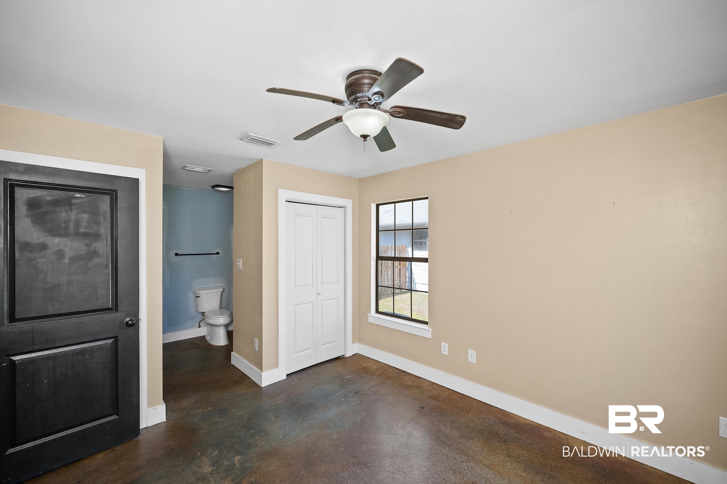 2000 Maria Lane Lillian, AL 36549 - Photo 8 of 35 Unfurnished bedroom with concrete floors, a closet, and a ceiling fan
