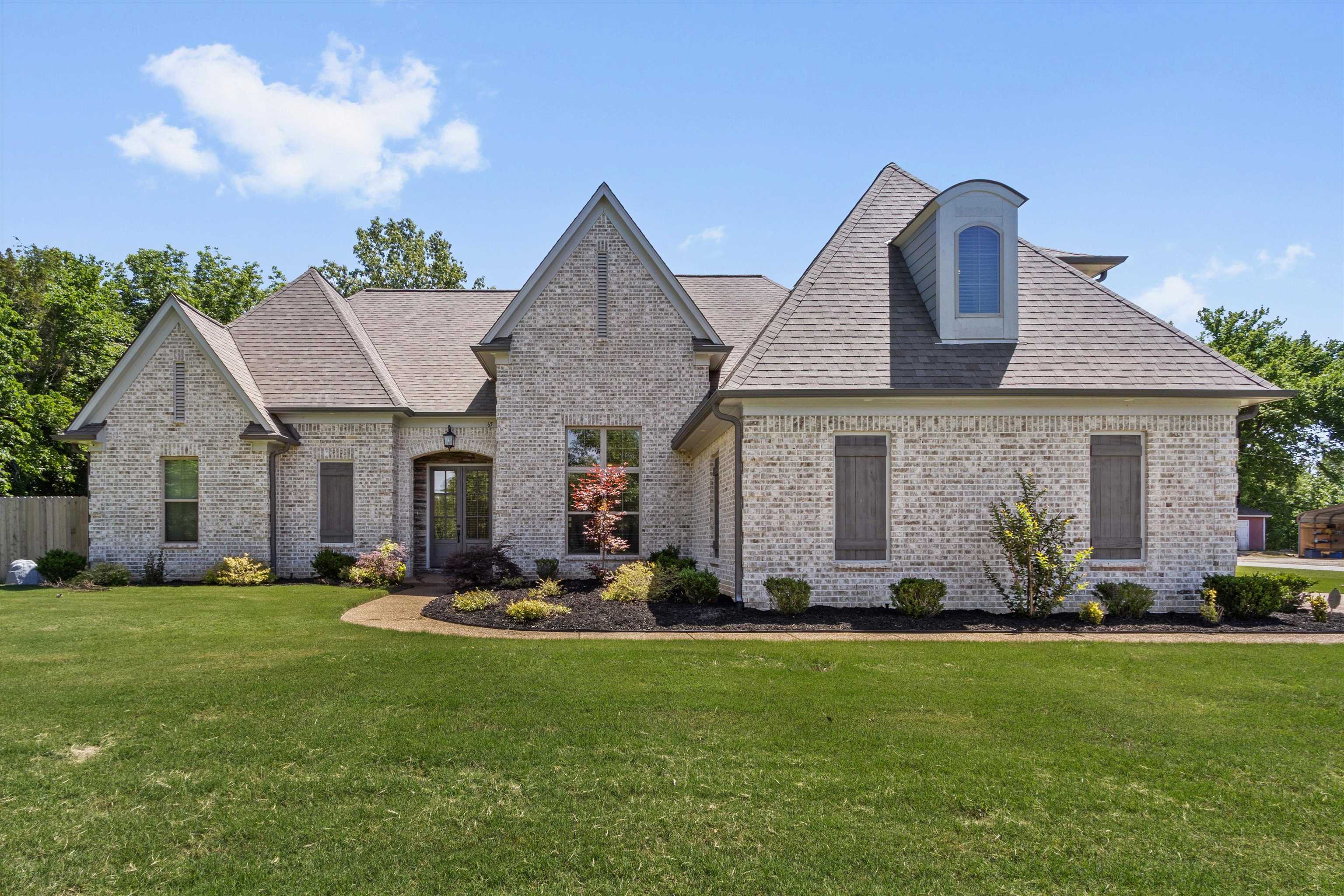 65 Watson Road Oakland, TN 38060 - Photo 1 of 40 a front view of house with yard and green space