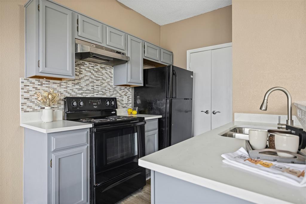 4113 Esters Road, Unit 609 Irving, TX 75038 - Photo 3 of 18 a kitchen with stainless steel appliances a sink a stove and a refrigerator