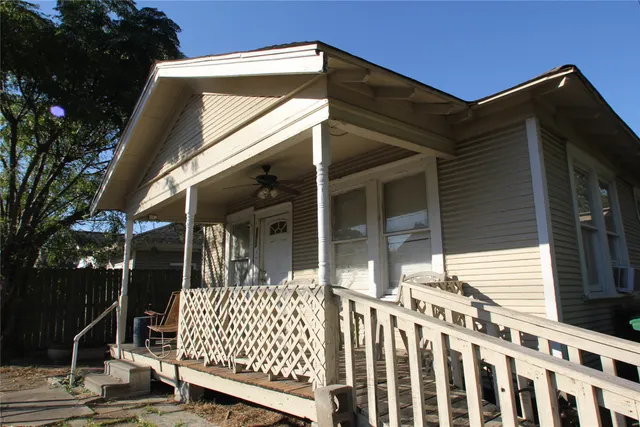 a view of a house with wooden fence