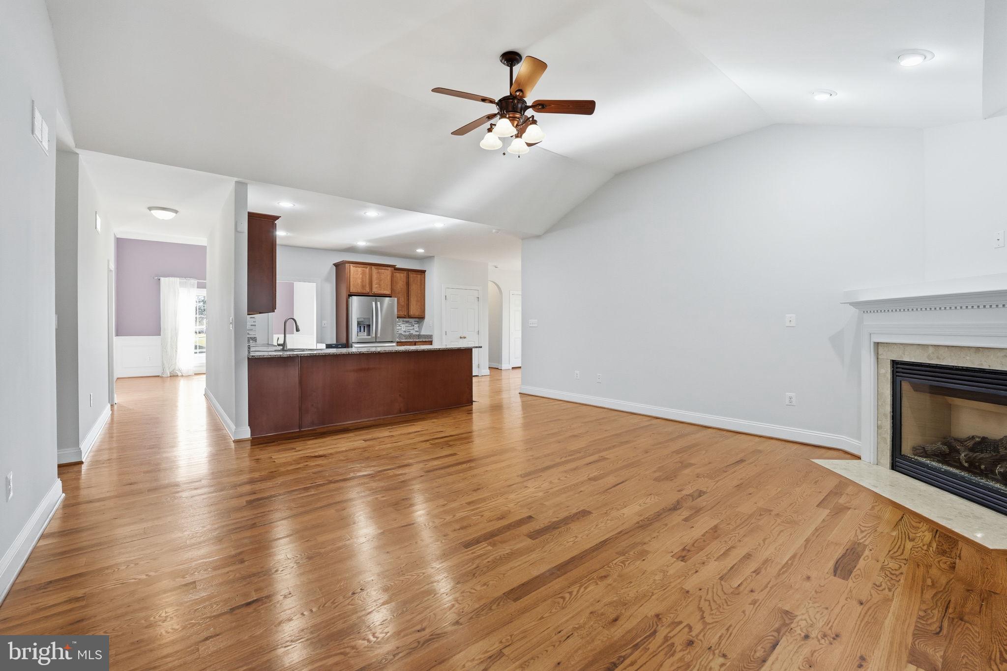 450 Canyon Road Winchester, VA 22602 - Photo 18 of 51 a view of a livingroom with a fireplace a ceiling fan and wooden floor