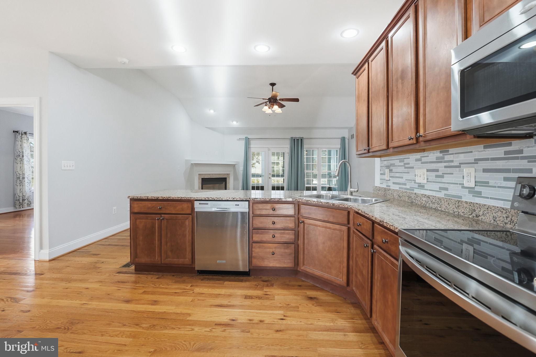 450 Canyon Road Winchester, VA 22602 - Photo 23 of 51 a kitchen with granite countertop a sink cabinets stainless steel appliances and a counter space