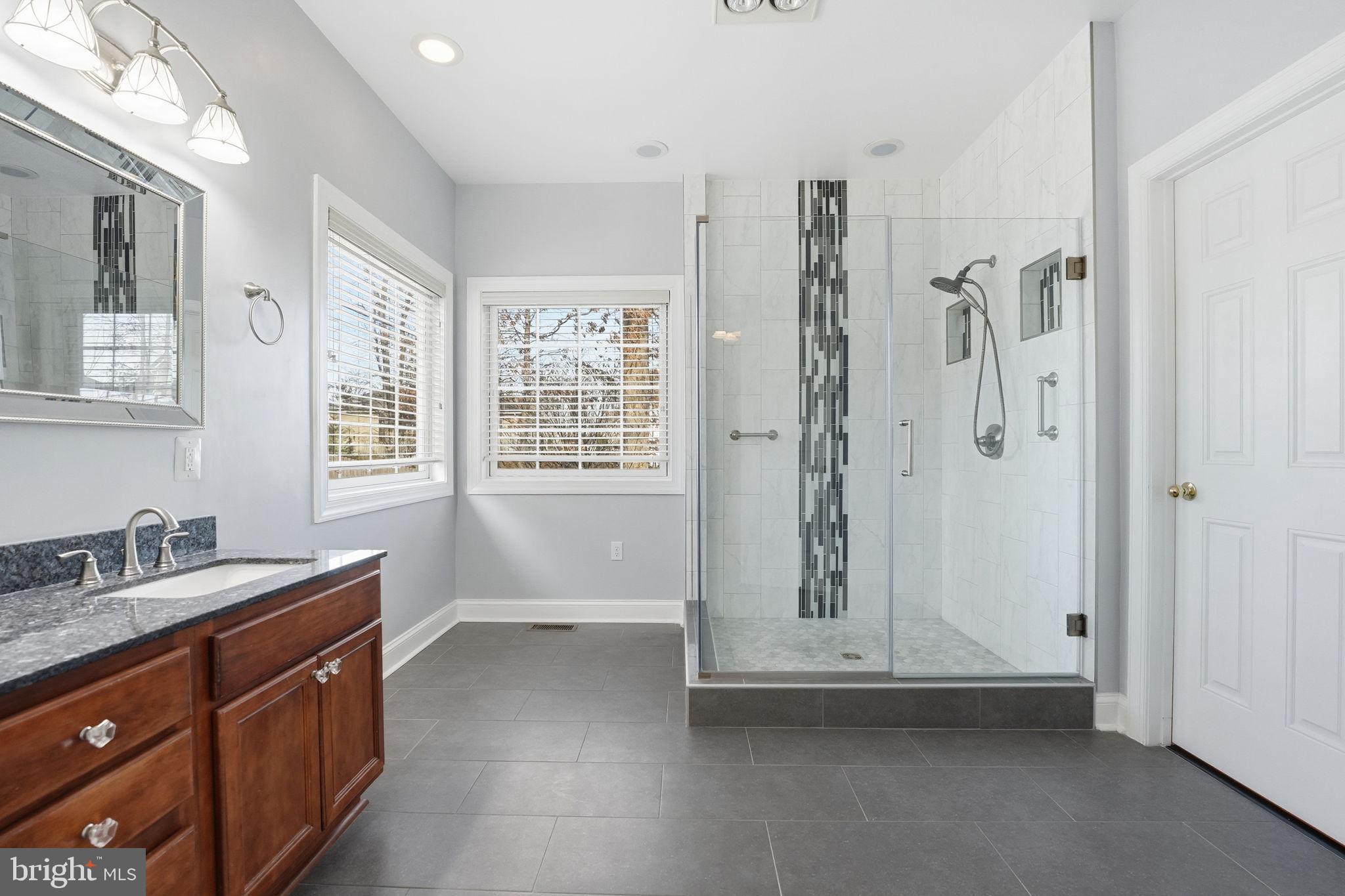 450 Canyon Road Winchester, VA 22602 - Photo 29 of 51 a bathroom with a granite countertop sink a mirror and a shower