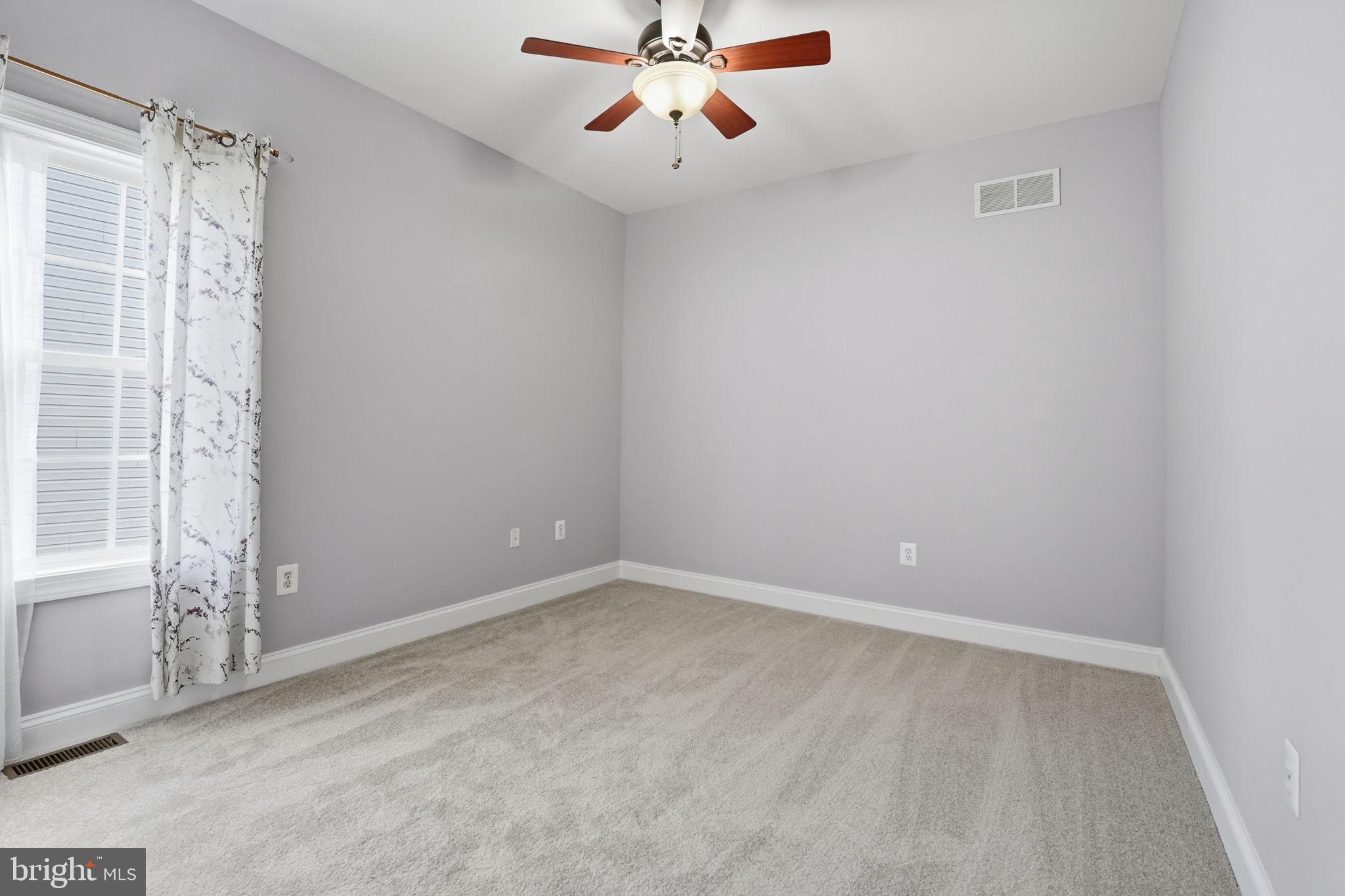 450 Canyon Road Winchester, VA 22602 - Photo 34 of 51 an empty room with windows and fan