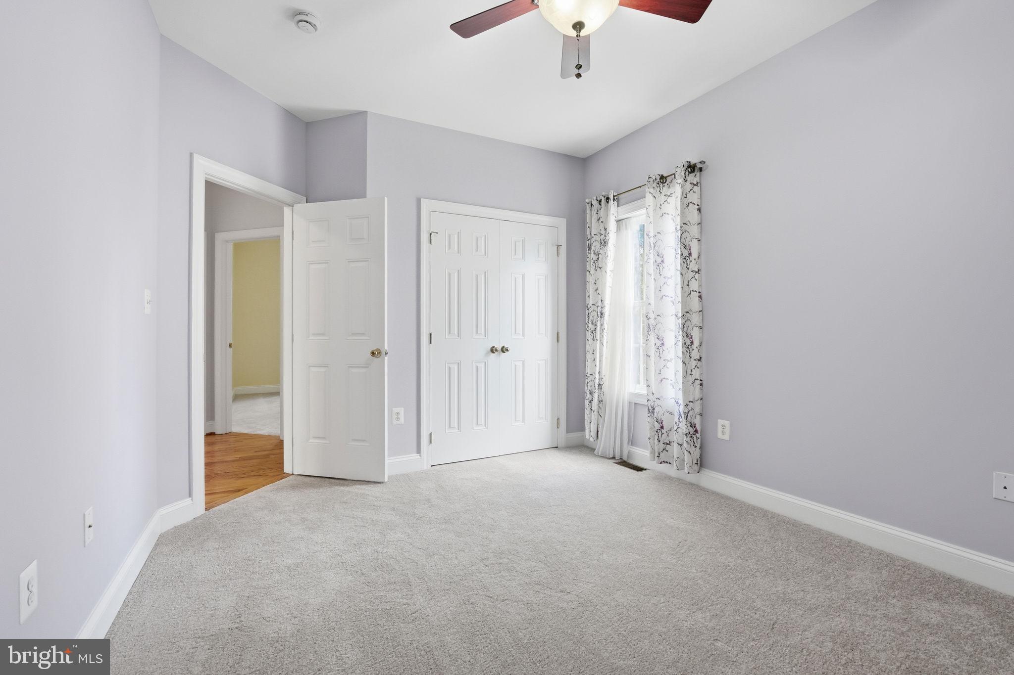 450 Canyon Road Winchester, VA 22602 - Photo 35 of 51 an empty room with chandelier fan and windows