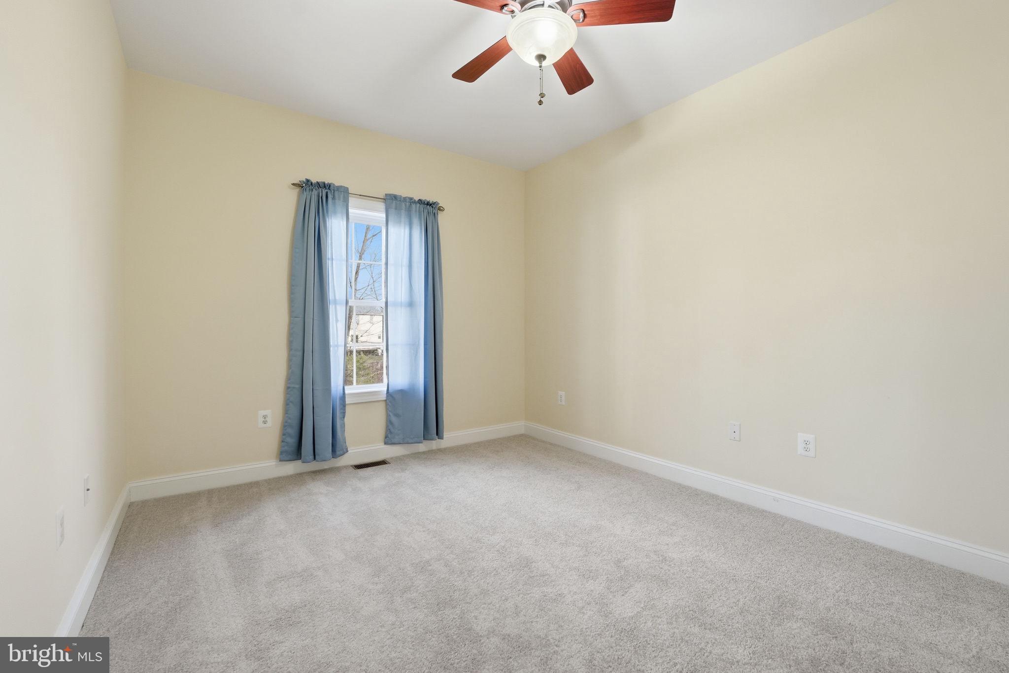 450 Canyon Road Winchester, VA 22602 - Photo 38 of 51 an empty room with a ceiling fan and window