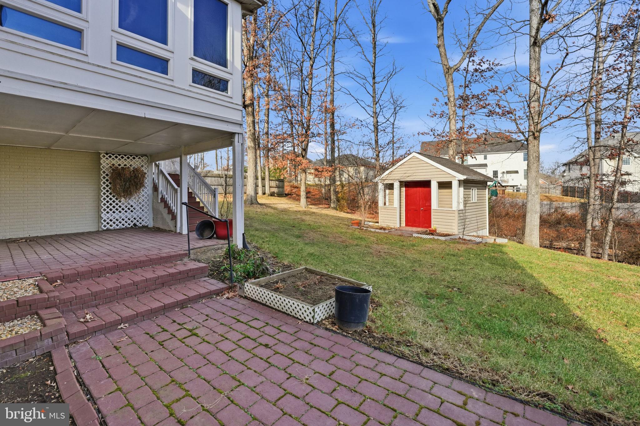 450 Canyon Road Winchester, VA 22602 - Photo 45 of 51 a view of a house with brick walls and a yard with plants