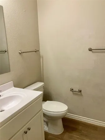 a white toilet sitting next to a white sink