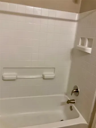 a bathroom with a shower and a bath tub