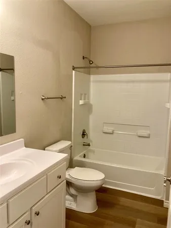 a bathroom with a toilet a sink and a shower