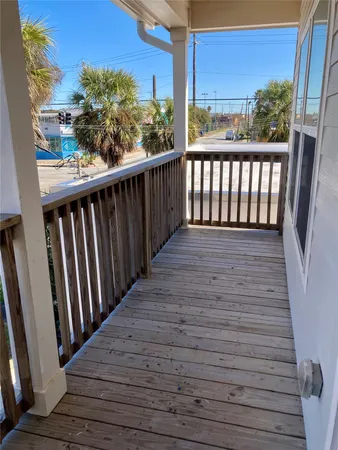 a view of a balcony with wooden floor