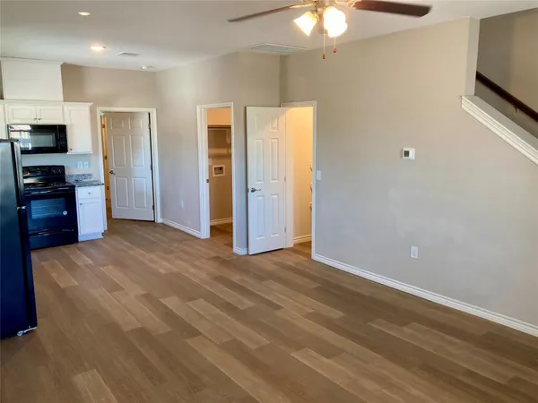 a view of a kitchen with a sink a refrigerator a microwave and a refrigerator
