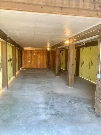 a view of a hallway with wooden shelves