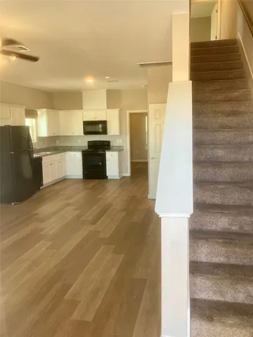 a view of kitchen with sink and microwave