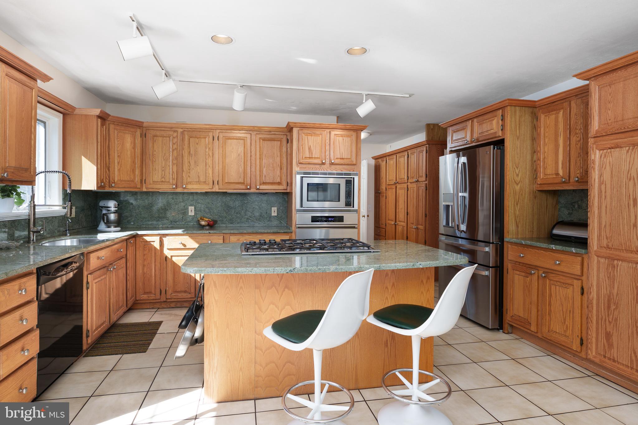 28 Talbot Lane Princeton, NJ 08540 - Photo 14 of 55 a kitchen with stainless steel appliances granite countertop a stove a sink and a refrigerator