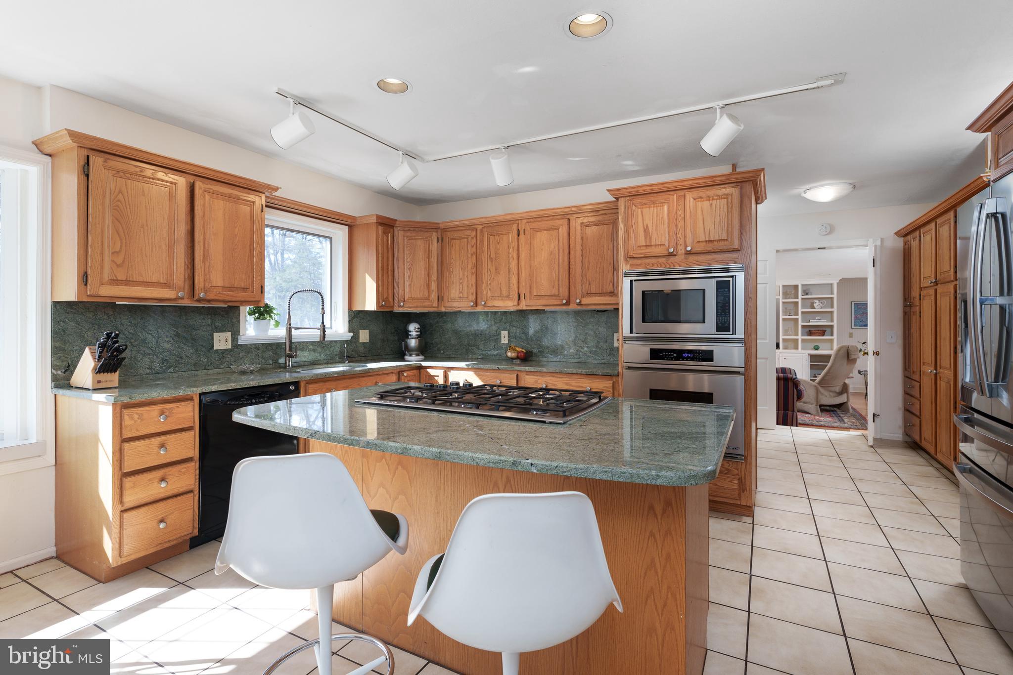 28 Talbot Lane Princeton, NJ 08540 - Photo 15 of 55 a kitchen with stainless steel appliances granite countertop a stove sink microwave and cabinets