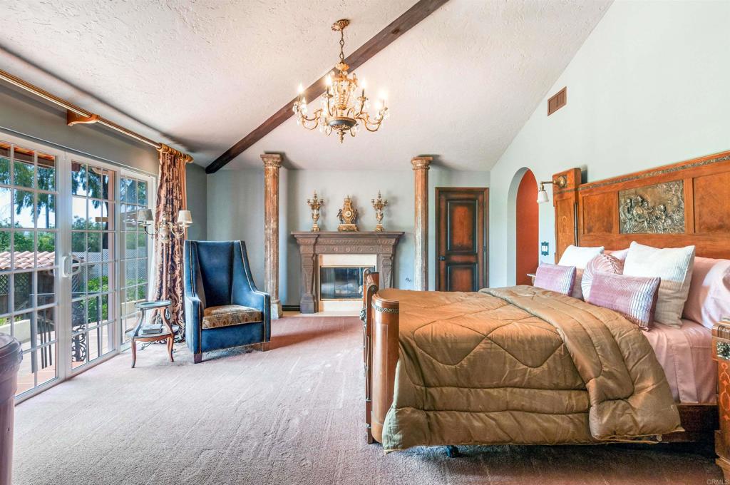 725 Hamilton Lane Fallbrook, CA 92028 - Photo 17 of 54 a bedroom with a bed couch and a large window