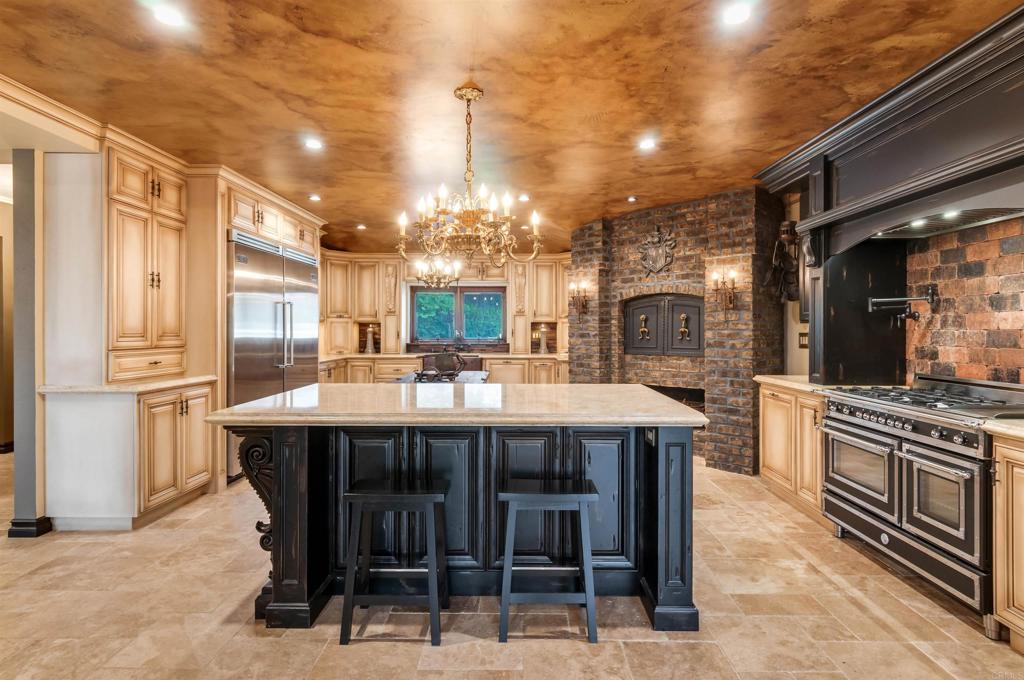 725 Hamilton Lane Fallbrook, CA 92028 - Photo 25 of 54 a large kitchen with a table and chairs